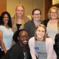 A group of women standing together, smiling